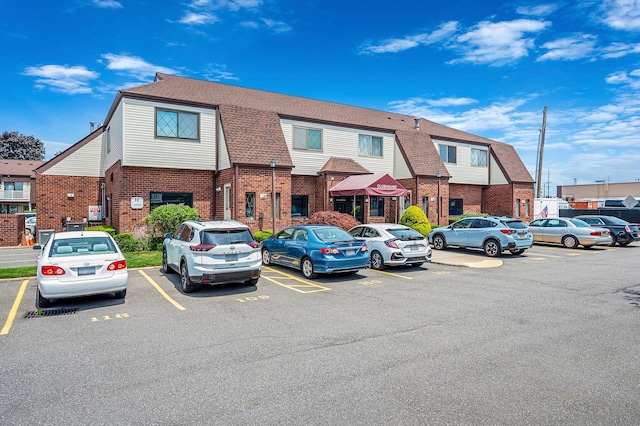 199 Cambridge Dr E, Copiague, NY 11726 - view of building exterior featuring uncovered parking