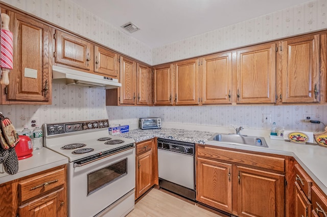 199 Cambridge Dr E, Copiague, NY 11726 - kitchen featuring white appliances, wallpapered walls, under cabinet range hood, and light countertops