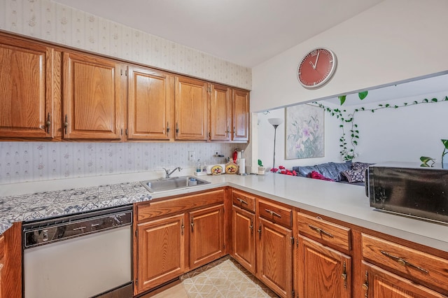 199 Cambridge Dr E, Copiague, NY 11726 - kitchen with white dishwasher, wallpapered walls, light countertops, brown cabinets, and black microwave