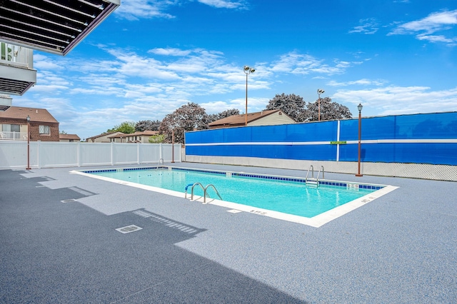 199 Cambridge Dr E, Copiague, NY 11726 - community pool with a fenced backyard and a patio
