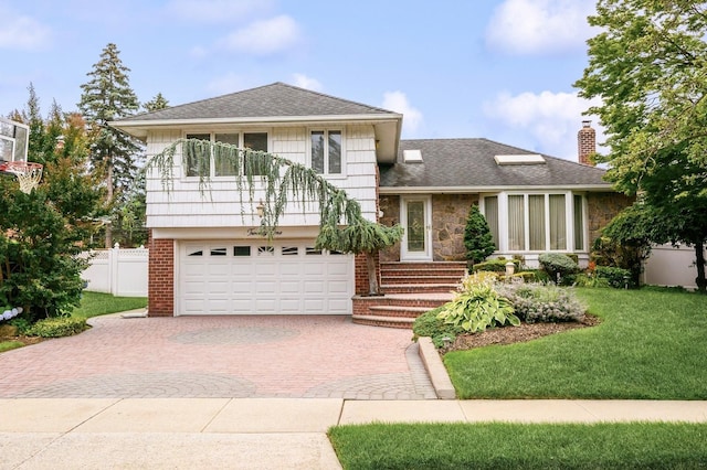 21 Hillvale Rd, Syosset, NY 11791 - split level home featuring decorative driveway, a garage, a shingled roof, a chimney, and stone siding