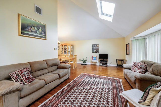 21 Hillvale Rd, Syosset, NY 11791 - living room with high vaulted ceiling, a skylight, and wood finished floors