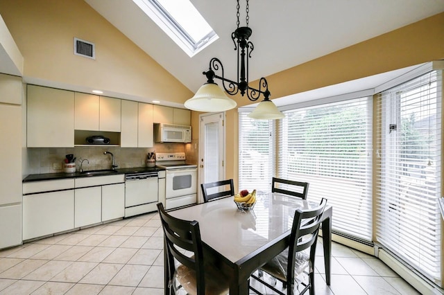 21 Hillvale Rd, Syosset, NY 11791 - dining room with a skylight, a baseboard radiator, light tile patterned floors, and high vaulted ceiling