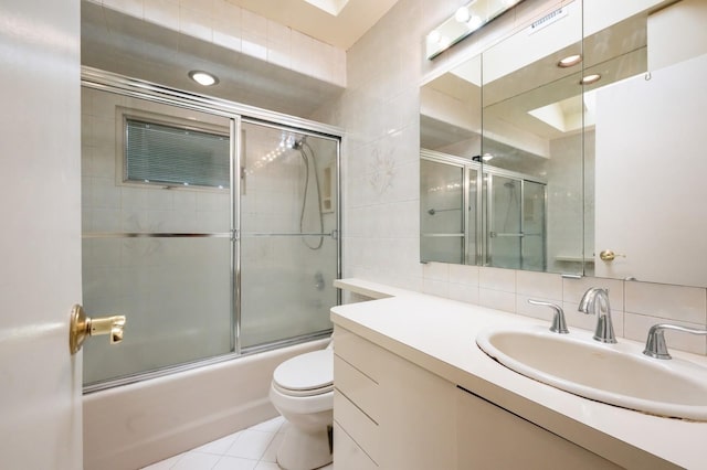 21 Hillvale Rd, Syosset, NY 11791 - bathroom with vanity, combined bath / shower with glass door, tile walls, and tile patterned flooring