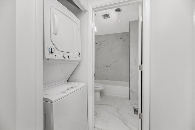 975 E 178th St, Bronx, NY 10460 - washroom featuring stacked washer / dryer and marble look tile flooring