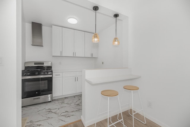 975 E 178th St, Bronx, NY 10460 - kitchen featuring gas range, white cabinets, light countertops, and light marble finish flooring