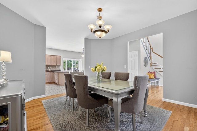 70 Hosner Mountain Rd, Hopewell Junction, NY 12533 - dining room featuring stairway, light wood finished floors, and a chandelier
