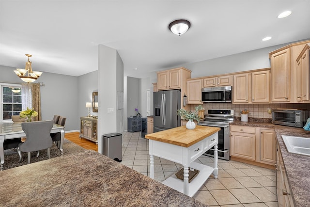 70 Hosner Mountain Rd, Hopewell Junction, NY 12533 - kitchen with light brown cabinets, stainless steel appliances, a chandelier, and backsplash