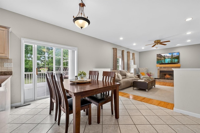 70 Hosner Mountain Rd, Hopewell Junction, NY 12533 - dining space with a ceiling fan, light tile patterned floors, recessed lighting, and a fireplace