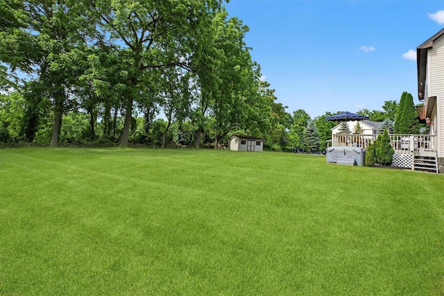 70 Hosner Mountain Rd, Hopewell Junction, NY 12533 - view of green lawn featuring a storage shed, a deck, and view of scattered trees