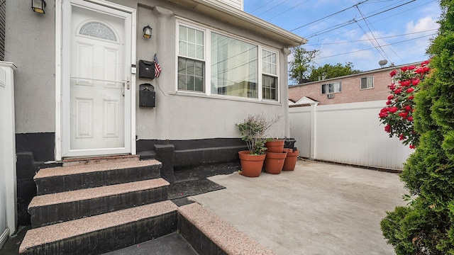 164-02 107th Ave, Jamaica, NY 11433 - view of exterior entry featuring stucco siding and a patio