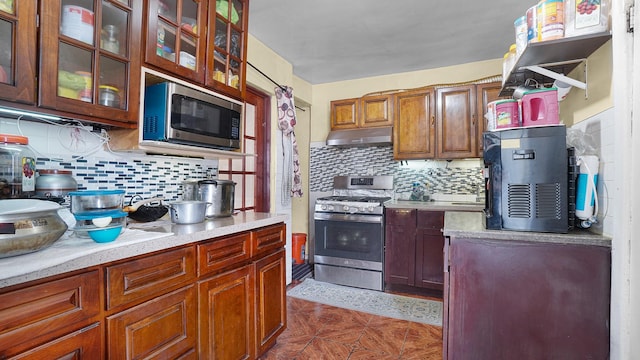 164-02 107th Ave, Jamaica, NY 11433 - kitchen with stainless steel appliances, under cabinet range hood, decorative backsplash, and light countertops