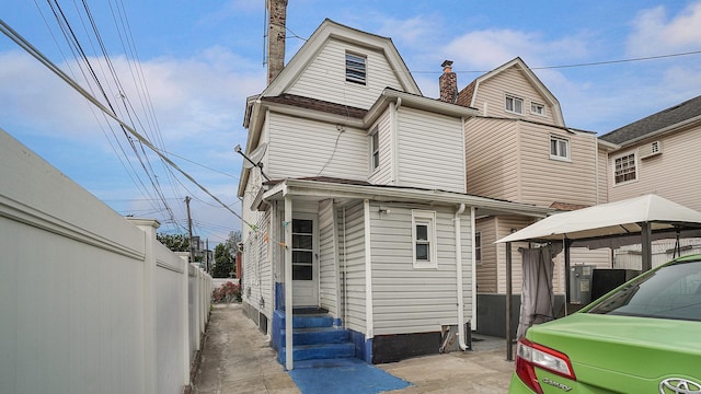 164-02 107th Ave, Jamaica, NY 11433 - back of house featuring entry steps, a gazebo, and a chimney
