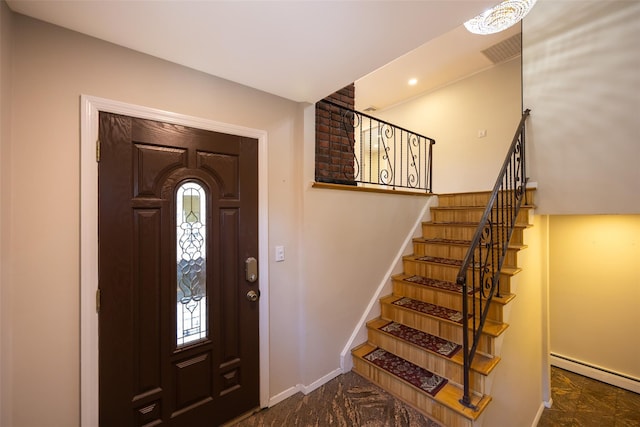 15 Linden St, Great Neck, NY 11021 - foyer entrance featuring a baseboard heating unit, stairs, and healthy amount of natural light