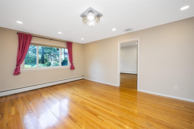 15 Linden St, Great Neck, NY 11021 - spare room featuring baseboard heating, a baseboard heating unit, light wood-style flooring, recessed lighting, and a chandelier