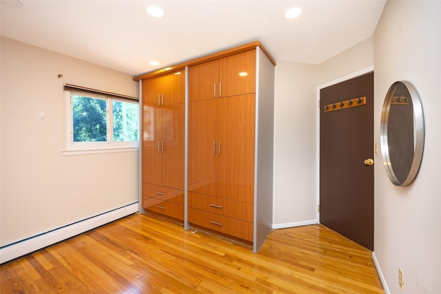 15 Linden St, Great Neck, NY 11021 - unfurnished bedroom with baseboard heating, light wood finished floors, and recessed lighting