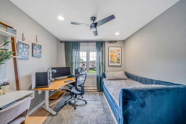 76 Keswick Ln, Plainview, NY 11803 - bedroom featuring light wood-style floors, an office area, a baseboard heating unit, recessed lighting, and ceiling fan