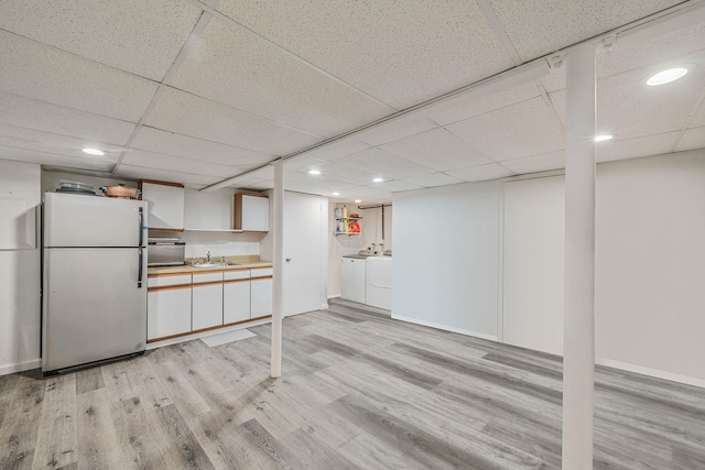 76 Keswick Ln, Plainview, NY 11803 - kitchen with freestanding refrigerator, washer and dryer, light wood-style flooring, recessed lighting, and a drop ceiling
