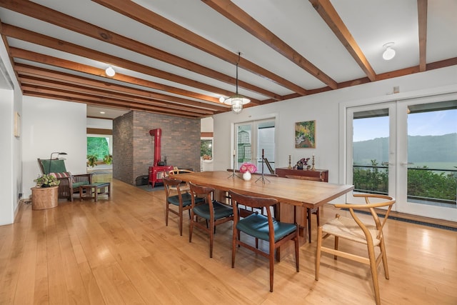 3778 State Route 82, Ancramdale, NY 12503 - dining space with a wood stove, beamed ceiling, light wood finished floors, and a mountain view