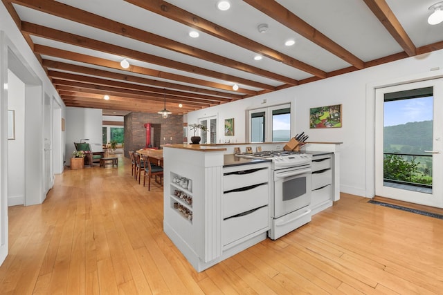3778 State Route 82, Ancramdale, NY 12503 - kitchen featuring white gas range, beamed ceiling, white cabinetry, light wood-style flooring, and recessed lighting