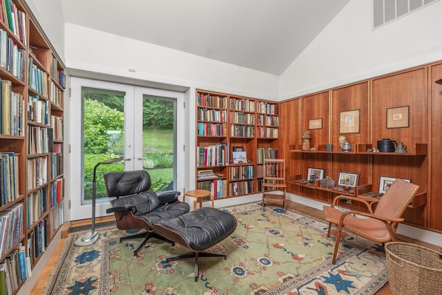 3778 State Route 82, Ancramdale, NY 12503 - sitting room featuring bookshelves, wood finished floors, high vaulted ceiling, and french doors