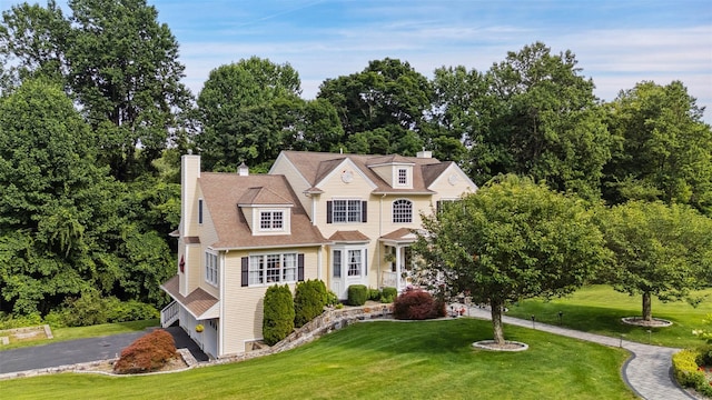 53 Quail Ln, Brewster, NY 10509 - shingle-style home featuring a front yard, a chimney, and view of wooded area