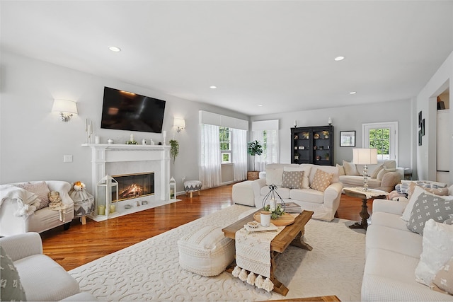 53 Quail Ln, Brewster, NY 10509 - living room with plenty of natural light, wood finished floors, a fireplace with flush hearth, and recessed lighting