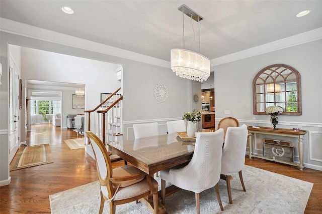 53 Quail Ln, Brewster, NY 10509 - dining area featuring a chandelier, crown molding, wood finished floors, stairs, and recessed lighting