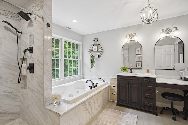 53 Quail Ln, Brewster, NY 10509 - full bathroom with a jetted tub, a marble finish shower, vanity, and wood finished floors