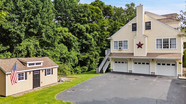 53 Quail Ln, Brewster, NY 10509 - view of side of property with a lawn, driveway, stairway, and a chimney