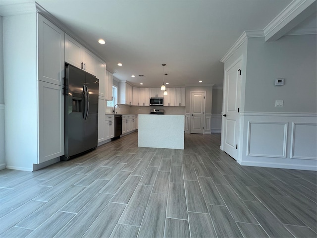 96 Baybright Dr, Shirley, NY 11967 - kitchen with appliances with stainless steel finishes, recessed lighting, ornamental molding, light countertops, and white cabinetry