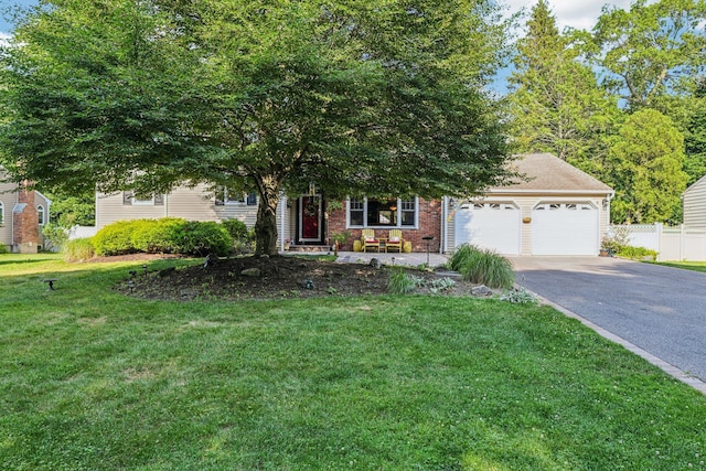 11 Kim Ave, Smithtown, NY 11787 - view of property hidden behind natural elements with an attached garage, asphalt driveway, and brick siding