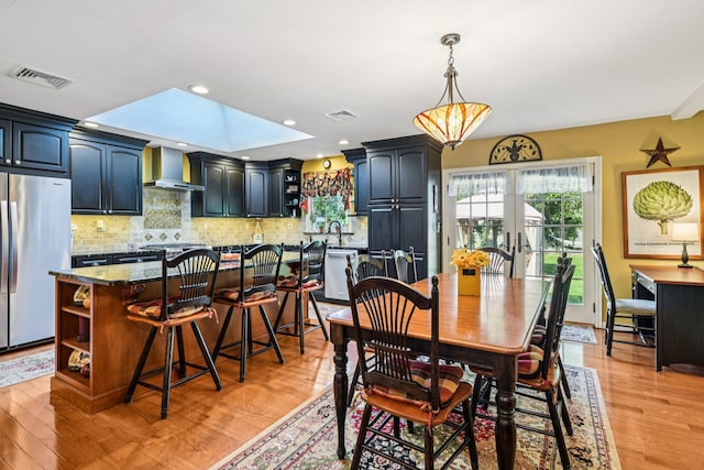 11 Kim Ave, Smithtown, NY 11787 - dining space with light wood-style floors, french doors, and recessed lighting