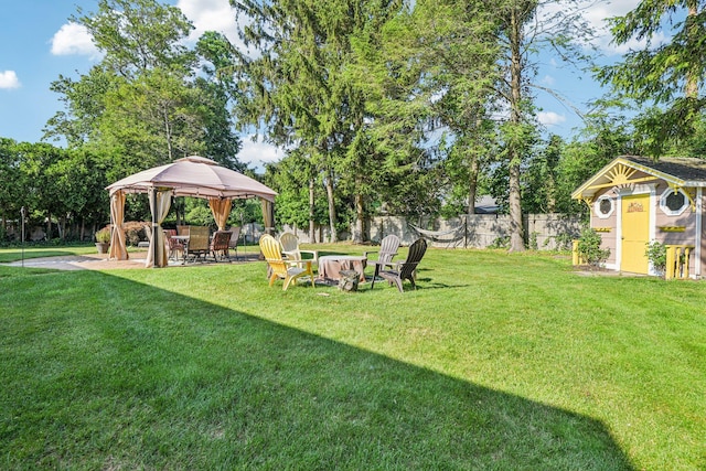 11 Kim Ave, Smithtown, NY 11787 - fenced backyard featuring a gazebo, a storage unit, and a fire pit