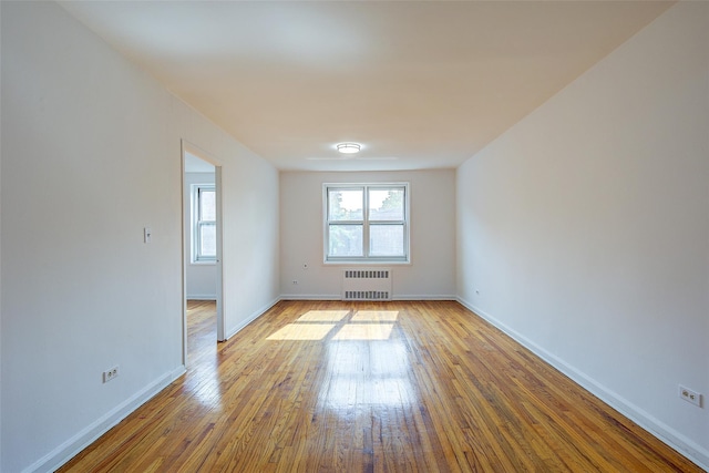 34-15 74th St Unit 5K, Jackson Heights, NY 11372 - unfurnished room featuring radiator heating unit and hardwood / wood-style floors