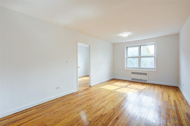 34-15 74th St Unit 5K, Jackson Heights, NY 11372 - empty room featuring radiator and light wood-style flooring