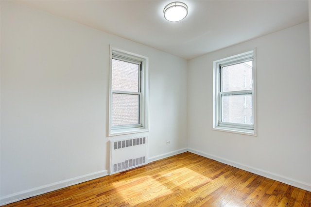 34-15 74th St Unit 5K, Jackson Heights, NY 11372 - spare room featuring radiator and light wood-style floors