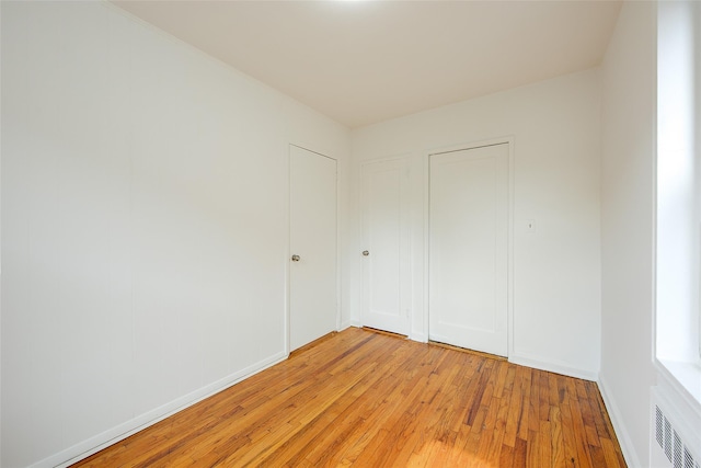 34-15 74th St Unit 5K, Jackson Heights, NY 11372 - unfurnished bedroom featuring light wood-style flooring and baseboards