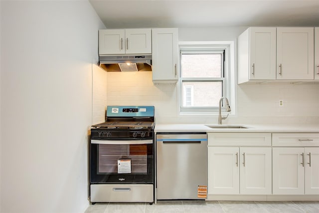 34-15 74th St Unit 5K, Jackson Heights, NY 11372 - kitchen with stainless steel appliances, under cabinet range hood, light countertops, white cabinets, and tasteful backsplash