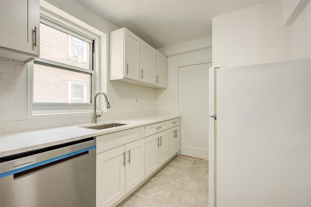 34-15 74th St Unit 5K, Jackson Heights, NY 11372 - kitchen featuring dishwasher, freestanding refrigerator, white cabinets, light countertops, and backsplash