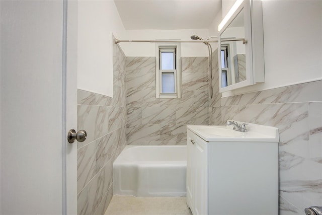34-15 74th St Unit 5K, Jackson Heights, NY 11372 - full bathroom with tile walls, vanity, shower / tub combination, and a wainscoted wall
