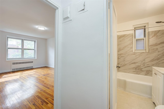 34-15 74th St Unit 5K, Jackson Heights, NY 11372 - full bath featuring radiator, shower / tub combination, hardwood / wood-style flooring, and vanity
