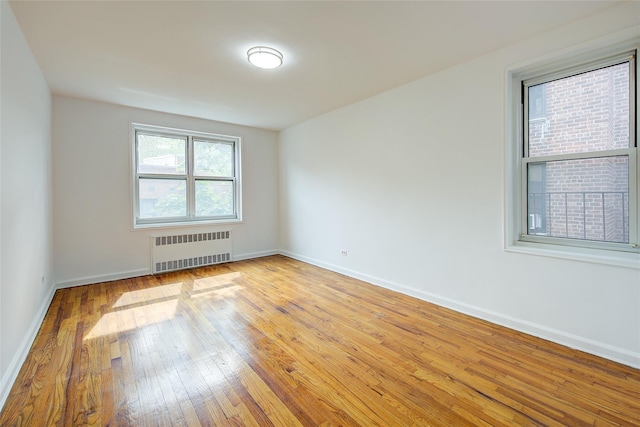 34-15 74th St Unit 5K, Jackson Heights, NY 11372 - empty room featuring radiator and light wood-type flooring