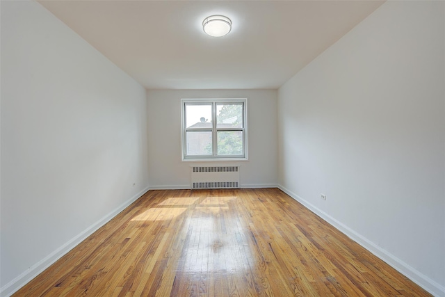 34-15 74th St Unit 5K, Jackson Heights, NY 11372 - spare room with radiator heating unit and light wood finished floors