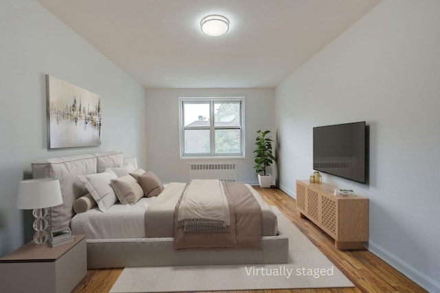 34-15 74th St Unit 5K, Jackson Heights, NY 11372 - bedroom featuring radiator and wood finished floors