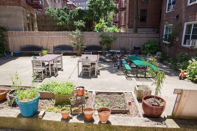 34-15 74th St Unit 5K, Jackson Heights, NY 11372 - view of patio with outdoor dining space, a vegetable garden, and cooling unit