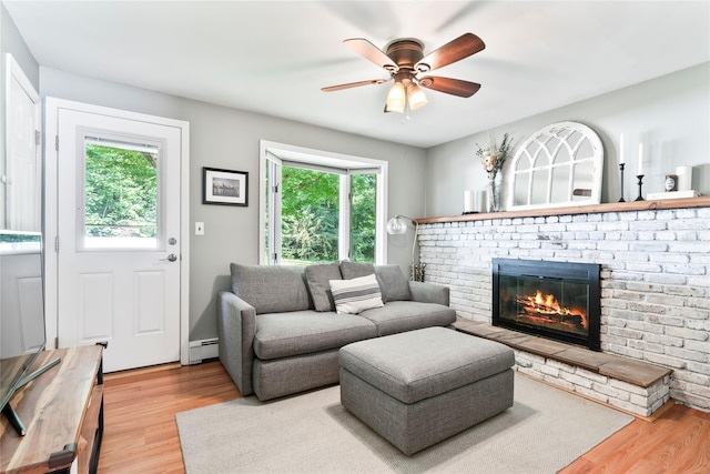15 Chambers Ct, Huntington Station, NY 11746 - living area with wood finished floors, a fireplace, ceiling fan, and a baseboard radiator
