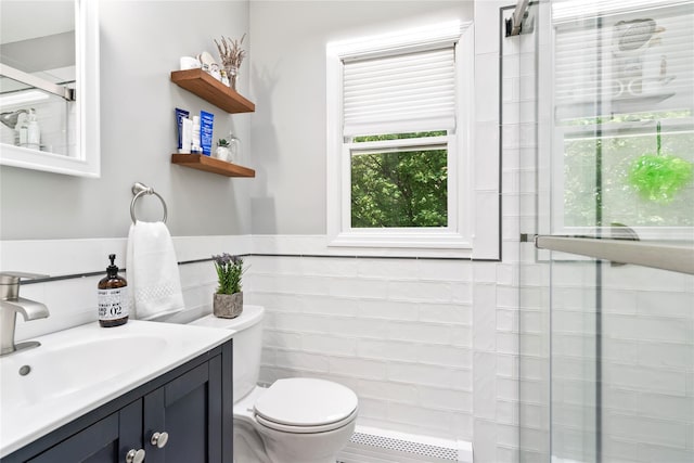 15 Chambers Ct, Huntington Station, NY 11746 - bathroom with a tile shower, vanity, tile walls, and wainscoting