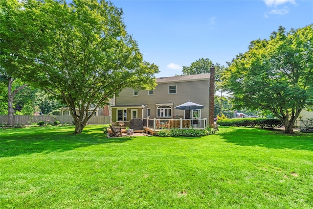 15 Chambers Ct, Huntington Station, NY 11746 - back of property with a chimney and a wooden deck