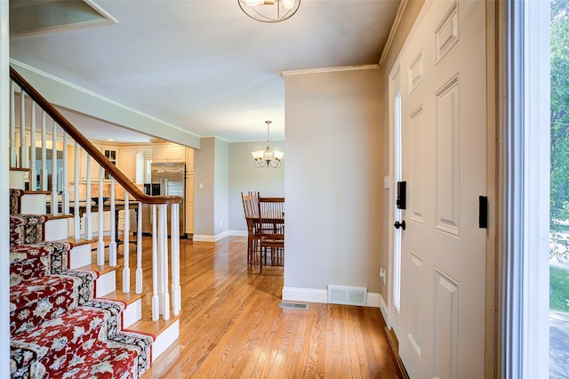 14 Flower Hill Rd, Poughkeepsie, NY 12603 - entrance foyer featuring light wood-style flooring, crown molding, stairway, plenty of natural light, and a chandelier